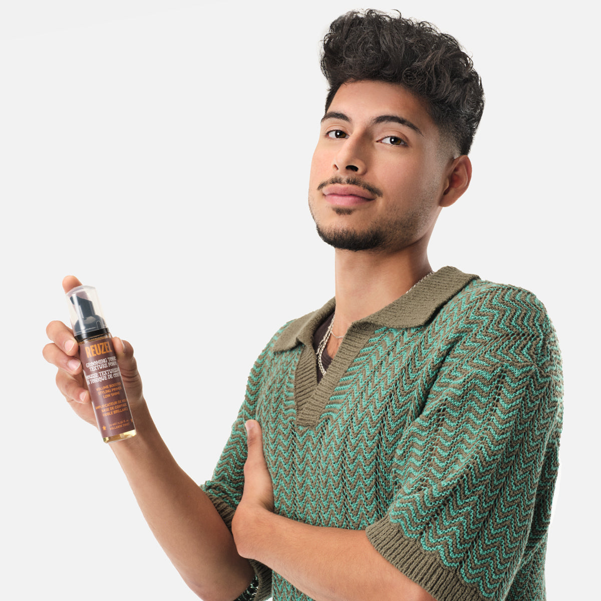 REUZEL UK Grooming Tonic Texture Foam for hair styling, shows the styling foam in a pump bottle with textured hair background.