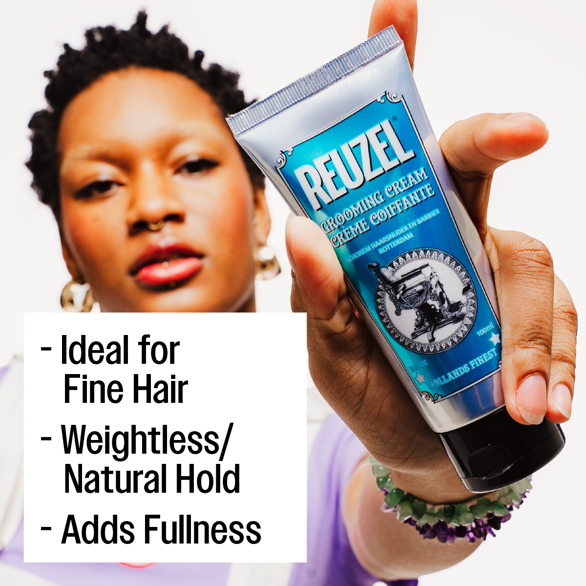 REUZEL UK grooming cream in a small jar, showing the product's smooth texture and branding on the label.