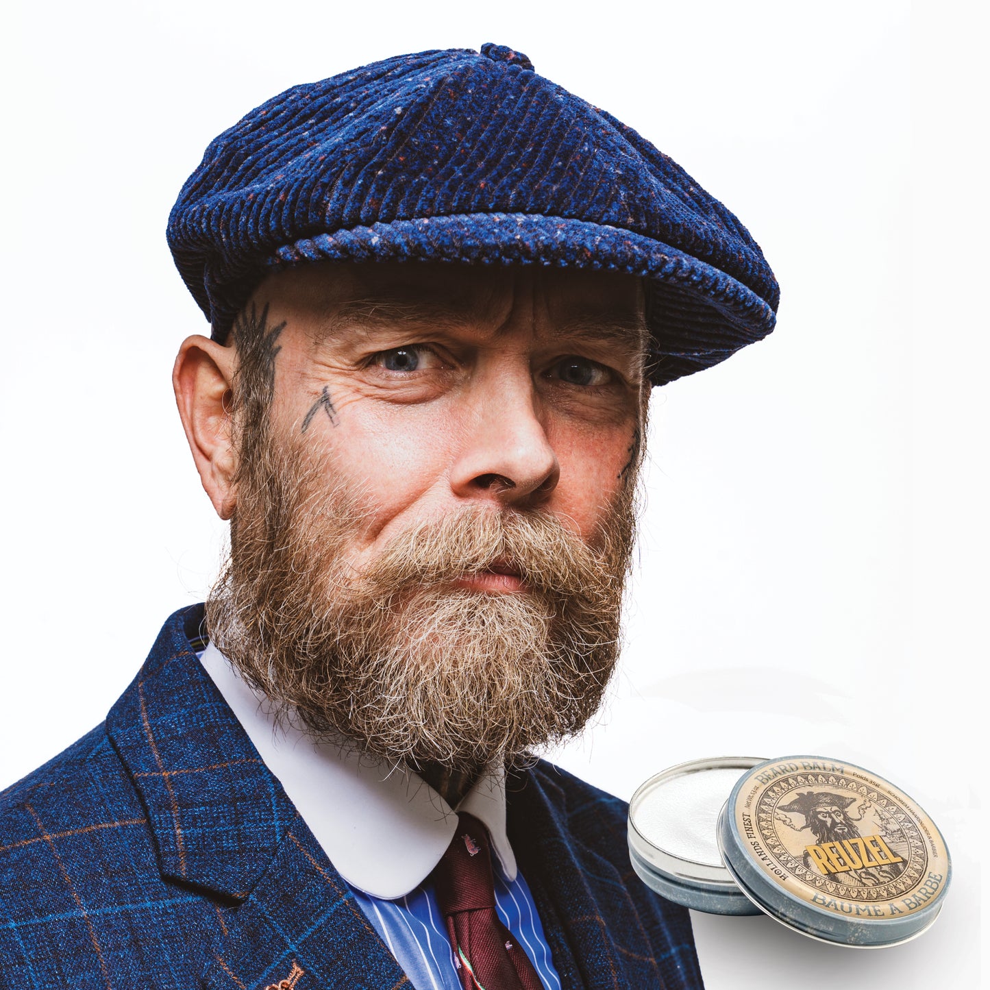 Reuzel UK Beard Balm with wood and spice scent, showing a jar of Reuzel Beard Balm on a wooden surface.