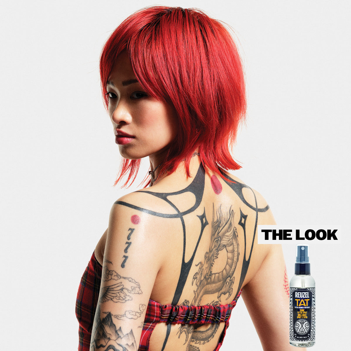 REUZEL UK TAT Duo exfoliating wash and shine spray for tattoo aftercare, featuring a bottle of each product with labels visible.
