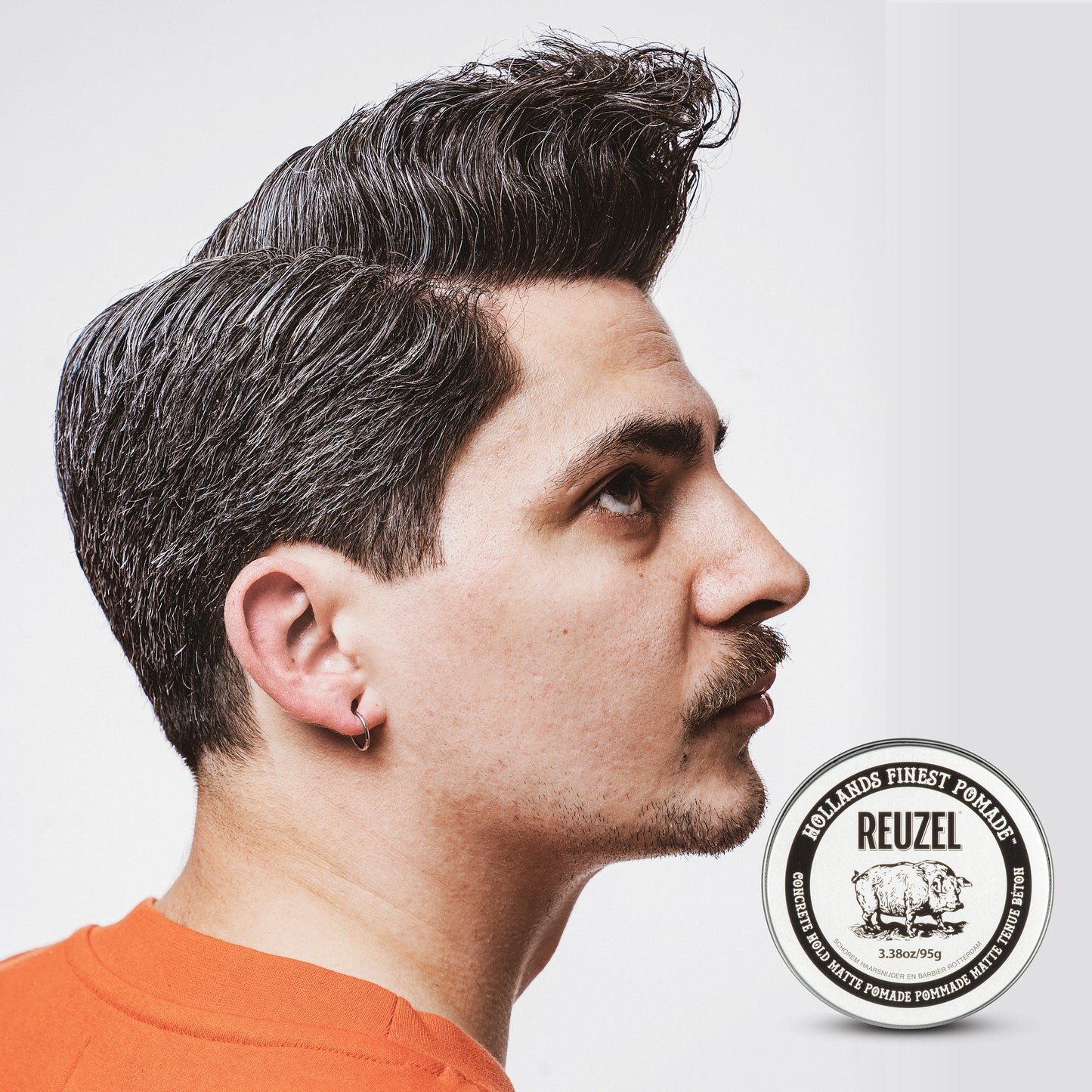 UK REUZEL Concrete Hold Matte Pomade in a jar, showcasing the product's matte finish and thick, creamy texture.