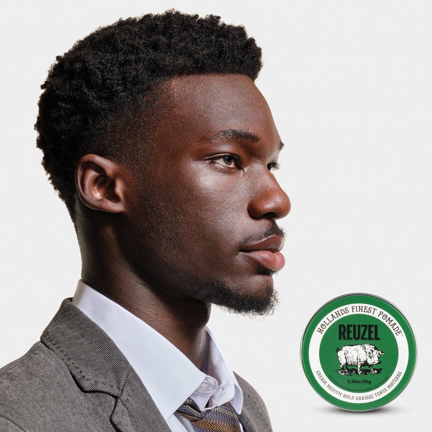 Reuzel Green Pomade jar with green lid and label, showcasing the classic styling product for hold and shine.