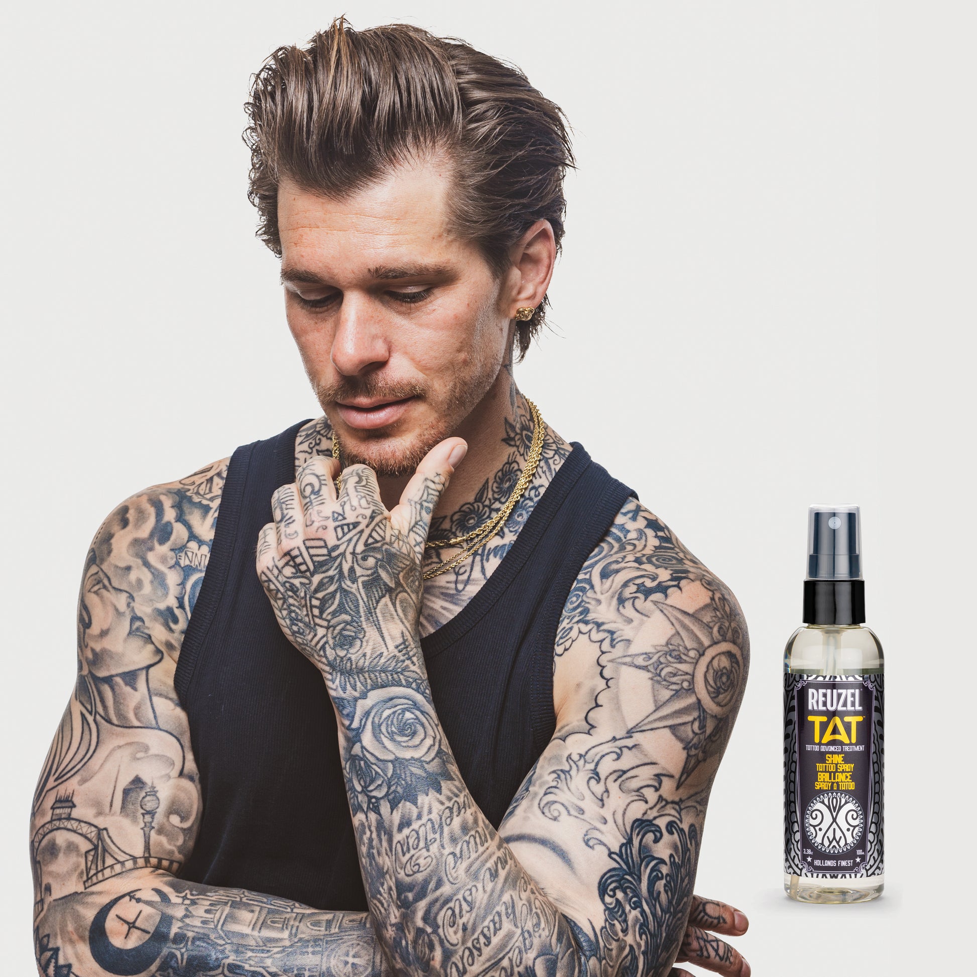 REUZEL UK SHINE Tattoo Spray, a tattoo aftercare product, featuring a sleek spray bottle with clear labeling and a modern design.
