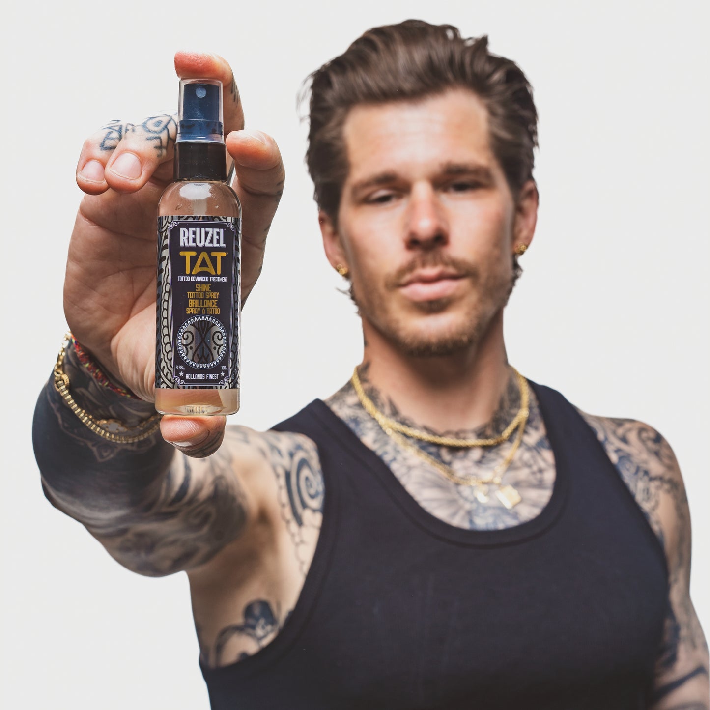 REUZEL UK SHINE Tattoo Spray for aftercare, featuring a sleek spray bottle for maintaining tattoo shine and hydration.