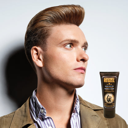 Man with styled hair next to a bottle of Reuzel Shave Butter on a gray background